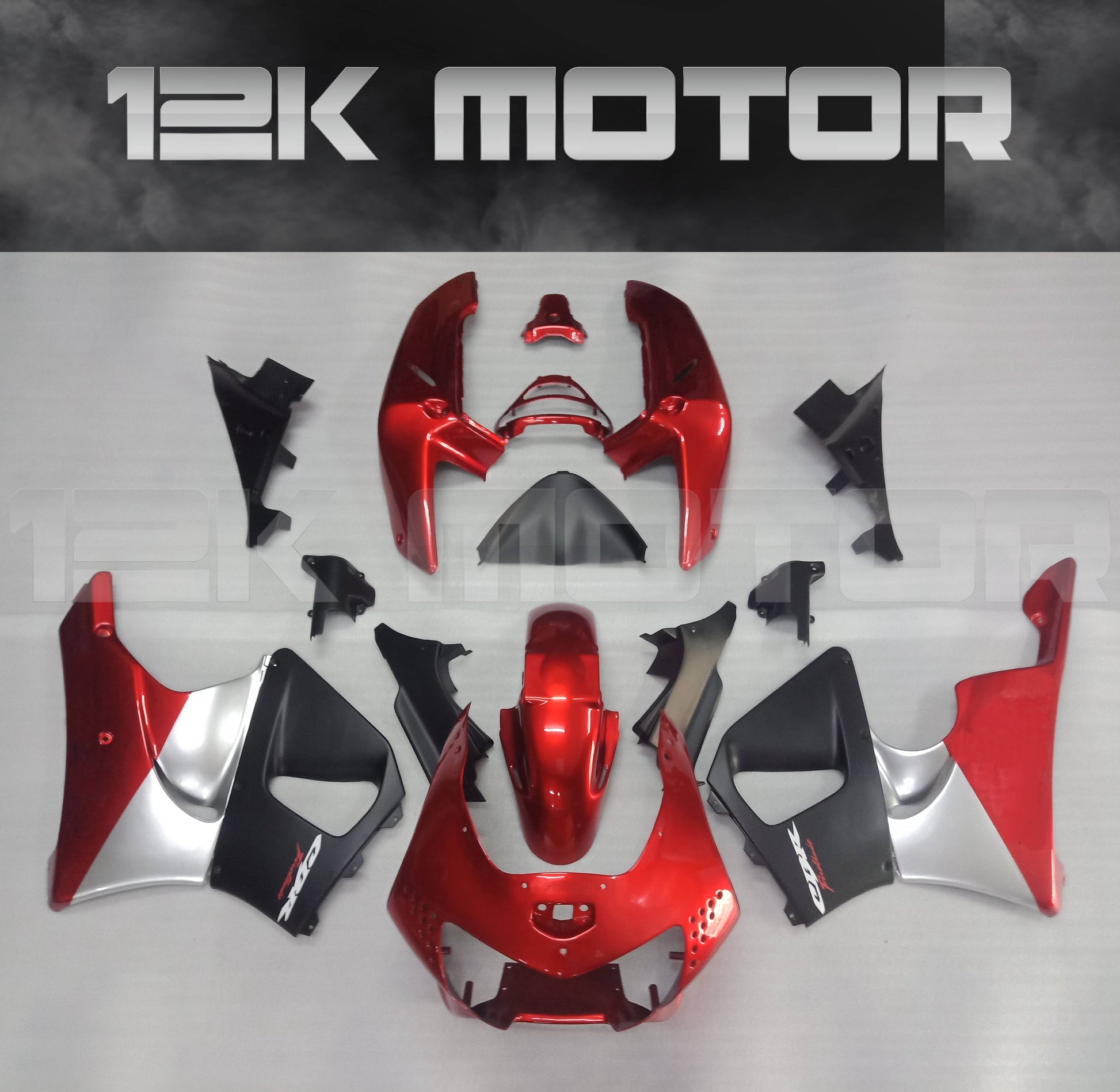 Aftermarket fairing kit for HONDA CBR900RR motorcycle, displayed on a table, featuring a red and black color scheme with various fairing pieces laid out separately.
