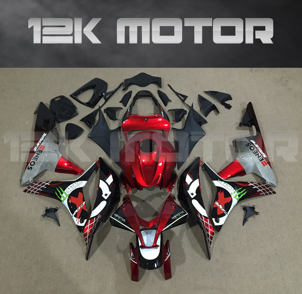 Aftermarket red fairing kit for HONDA CBR600RR motorcycle displayed on a table, including various panels and parts.