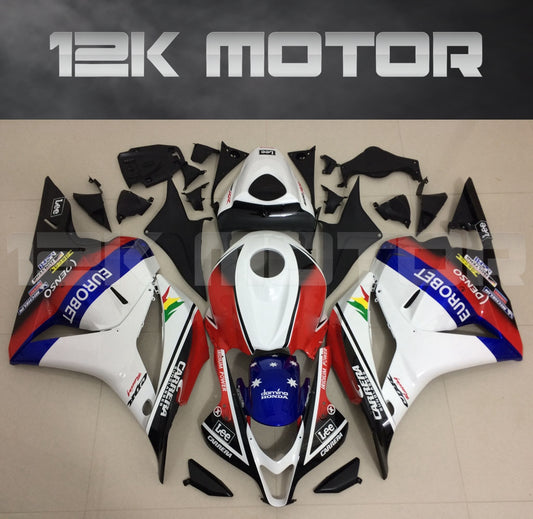 Aftermarket fairing kit for HONDA CBR600RR 2009-2012 displayed on a table, consisting of various pieces in red, white, blue, and black colors.