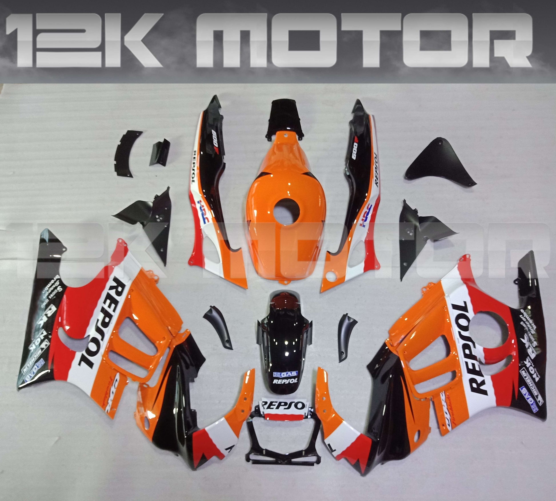 Aftermarket fairing kit for HONDA CBR600F, consisting of multiple pieces in orange, black, and white colors with Repsol branding.
