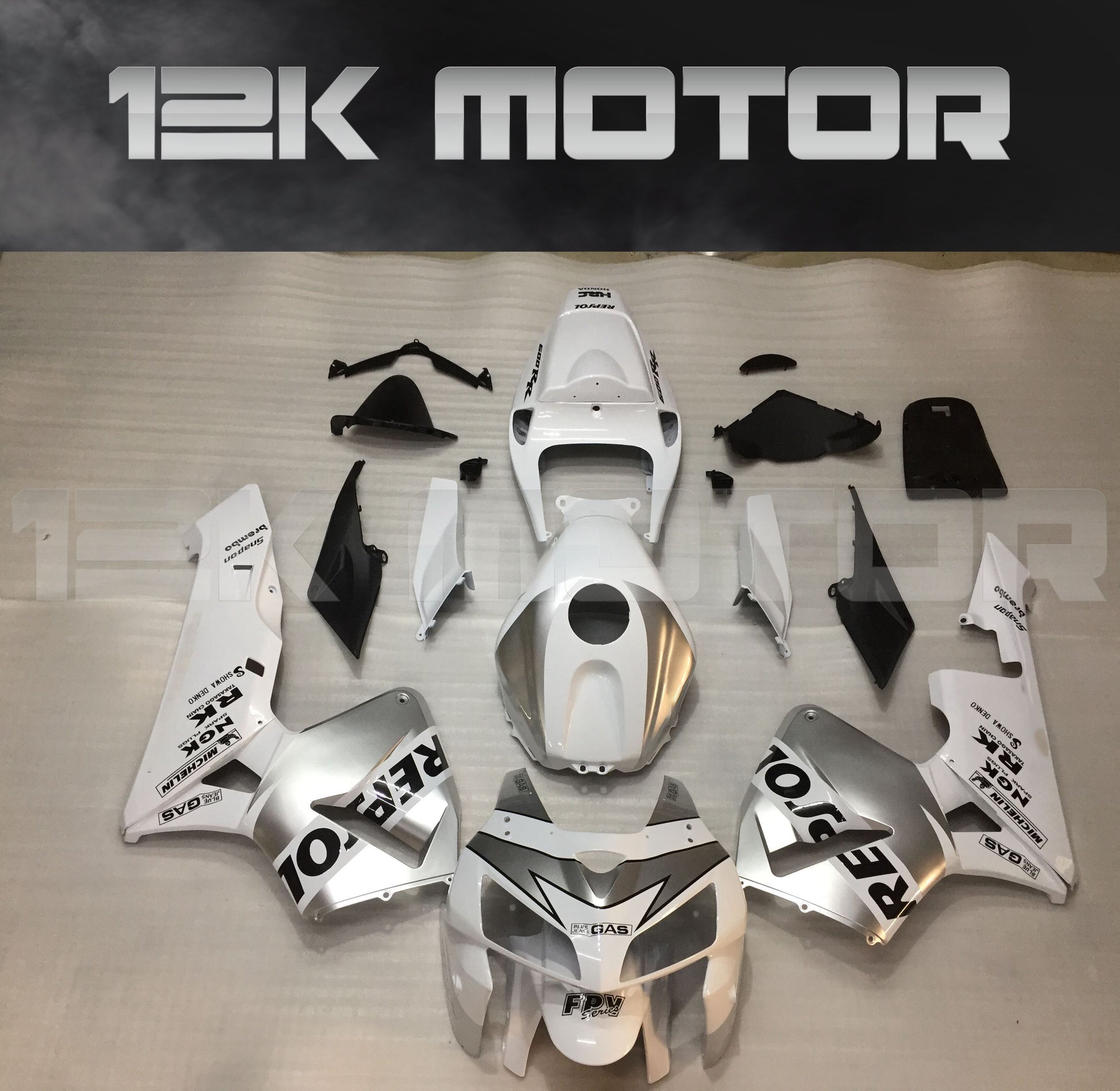 Aftermarket silver and white fairing kit for HONDA CBR600RR 2005 2006 displayed on a table.