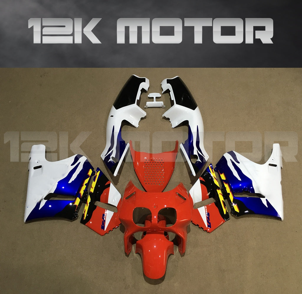 Aftermarket fairing kit for HONDA VFR 400, consisting of multiple pieces in red, white, and blue color scheme, displayed on a table.