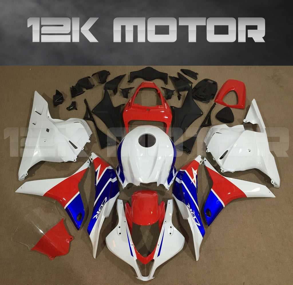 Aftermarket fairing kit for HONDA CBR600RR motorcycle, featuring white, red, and blue body panels laid out on a flat surface.